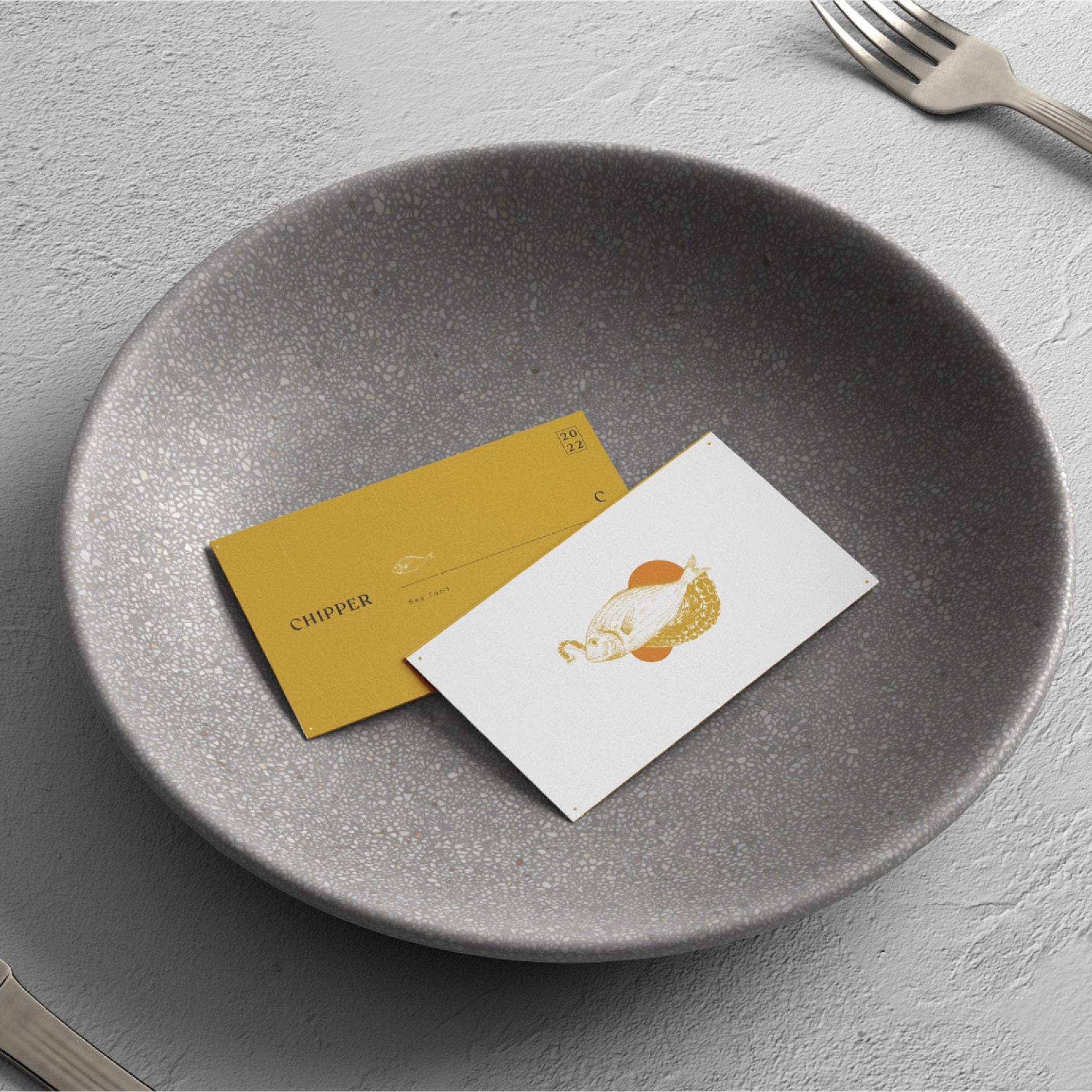 Business cards resting on a stone plate