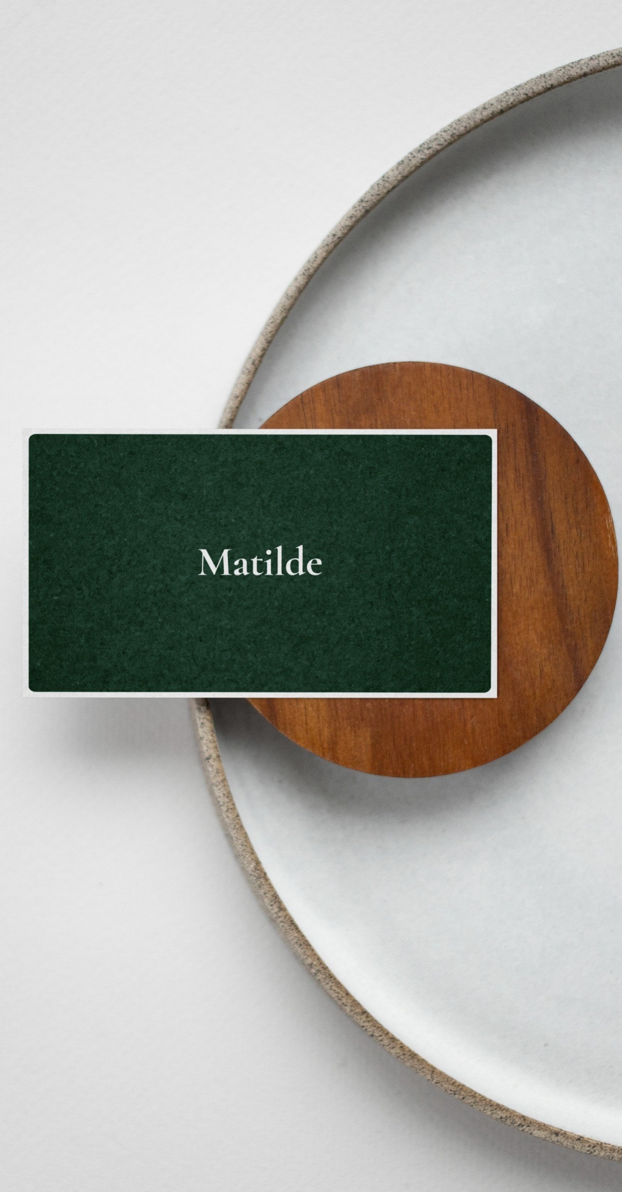 A green card resting on a wooden coaster