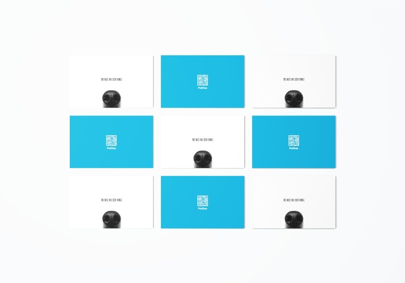 Business cards laid out over the brand blue